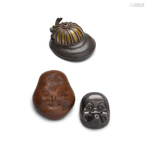 Two metal mask netsuke and a helmet netsuke Edo period (1615-1868), 19th century