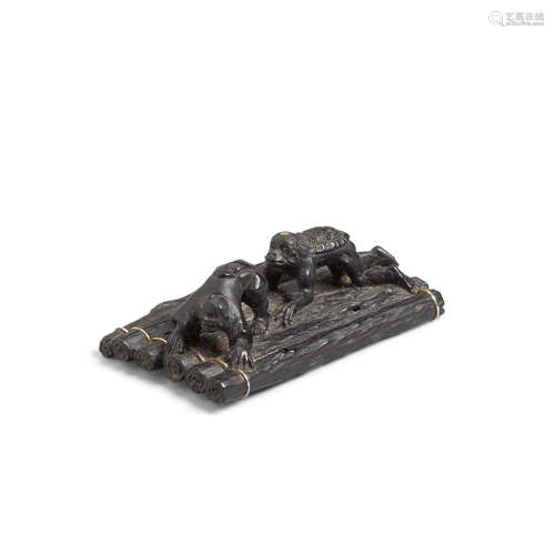 An ebony netsuke of a kappa on a raft by Sakurai Hideyuki (b. 1941)