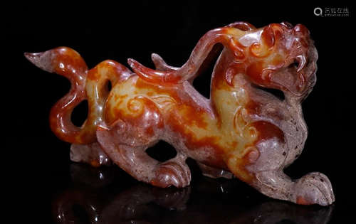 AN ANTIQUE JADE BEAST PENDANT