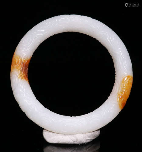 A HETIAN WHITE JADE BANGLE CARVED WITH BEAST PATTERN