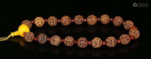 A WALNUT STRING BRACELET WITH 18 BEADS