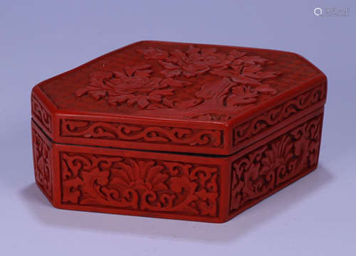 A RED LACQUER BOX CARVED WITH FLOWER