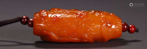 A HETIAN YELLOW JADE PENDANT CARVED WITH BEAST PATTERN