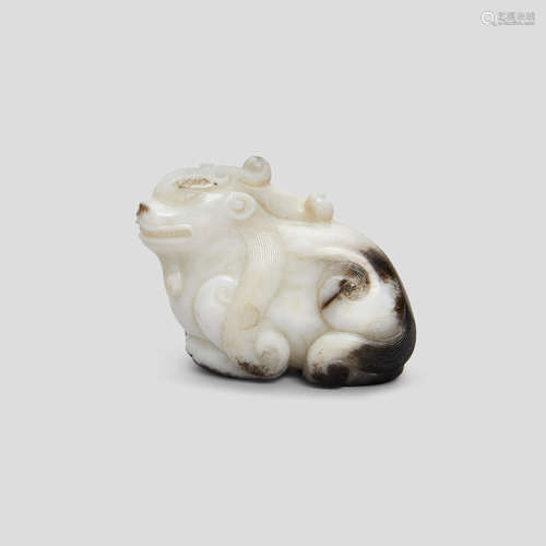 A black and white jade carving of a recumbent beast