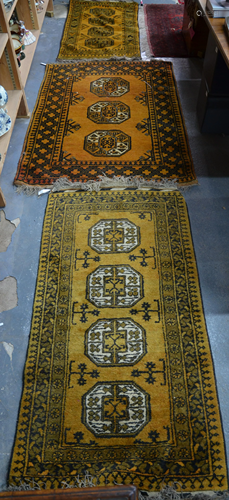 A trio of 'golden' Afghan rugs (3)