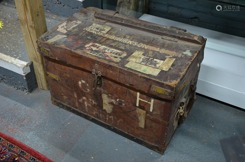 An antique heavy leather trunk and bivouac items