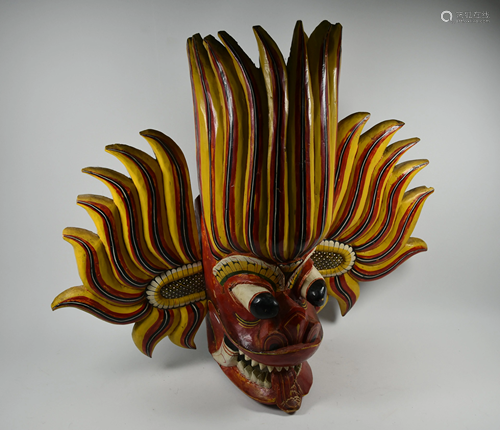 An antique Indian carved and painted wood Garuda head