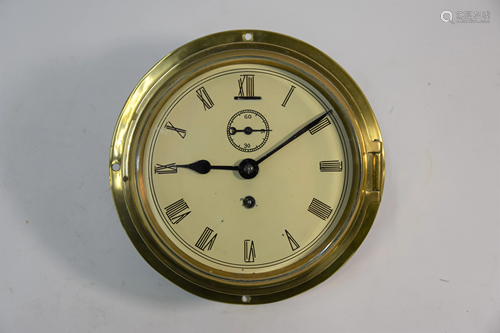 An old brass cased 8-day bulkhead clock