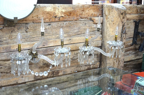 A pair of cut glass twin-branch wall sconces hung with