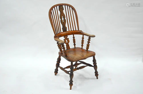 An antique elm seat hoop and stick back elbow chair