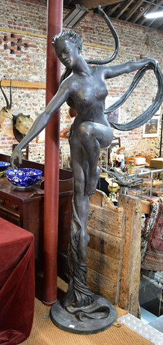 A large bronze patinated sculpture of an unclad female