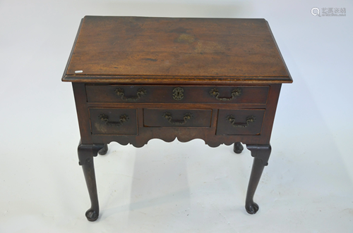 An 18th century oak lowboy with an arrangement of