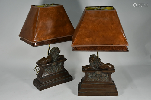 A pair of cast bronze resin table lamps as recumbent