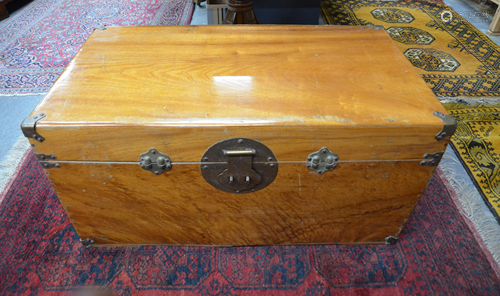 A brass bound camphorwood trunk