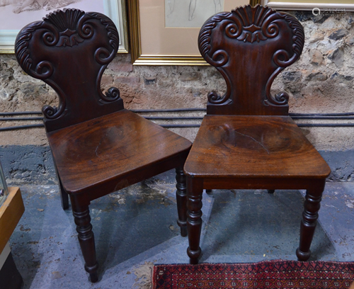 A pair of Victorian moulded shield back mahogany hall