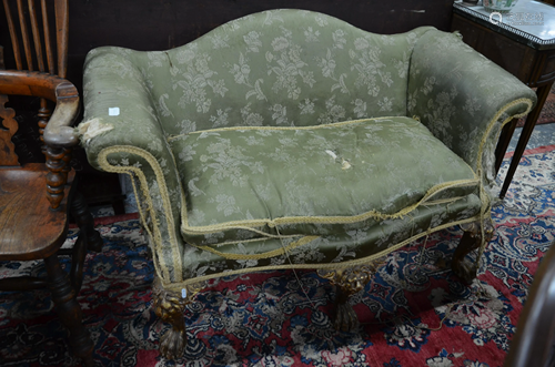 An antique hump back serpentine form sofa with scroll