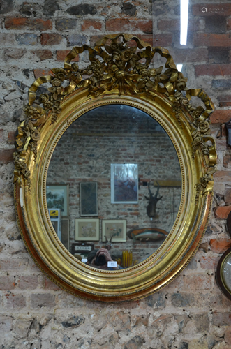 A large giltwood and composite framed oval mirror