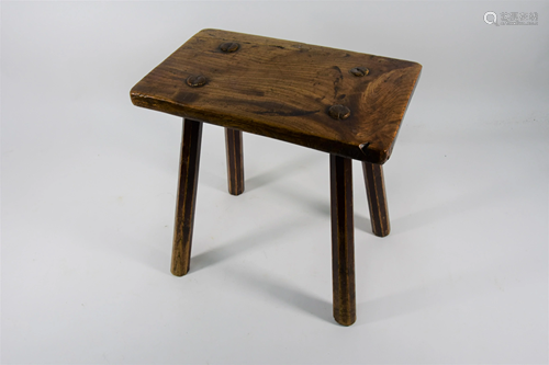 An antique rustic elm dairy stool