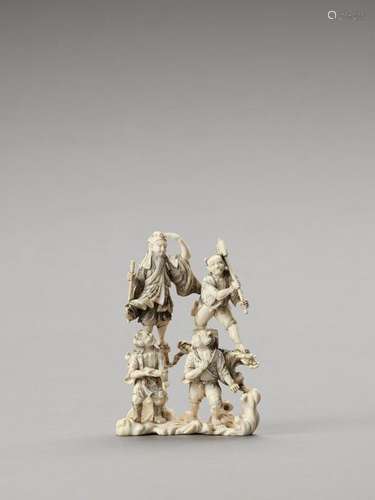 A Rare Ivory Okimono Of A Grou…