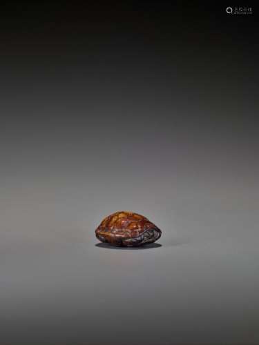 A Wood Netsuke Of A Retracted …