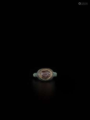 A Persian Bronze Ring With Rub…