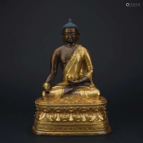 A gilt-bronze figure of Medicine Buddha