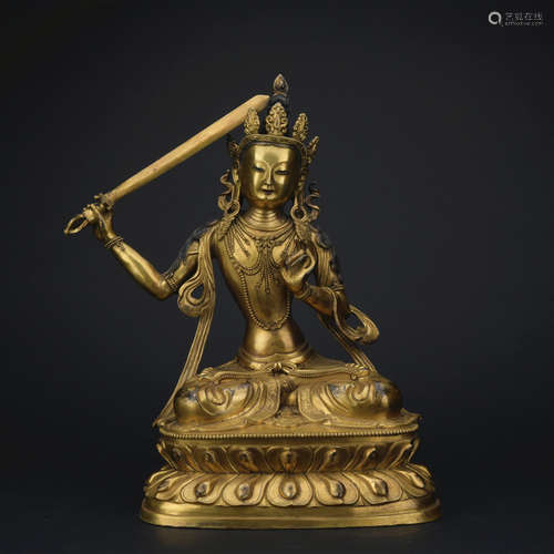 A gilt-bronze figure of Manjusri