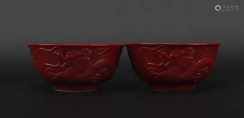 A pair of red glazed 'dragon' bowl