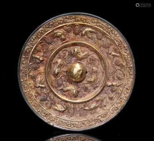 A GILT BRONZE MIRROR CARVED WITH FLOWERS