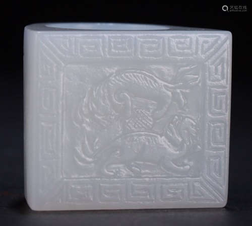 A HETIAN WHITE JADE RING CARVED WITH BEAST