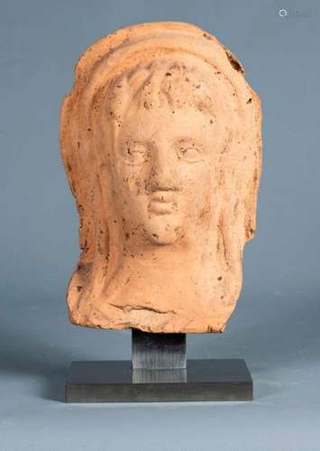 Votive head of a young man made of terracotta. \nGr…