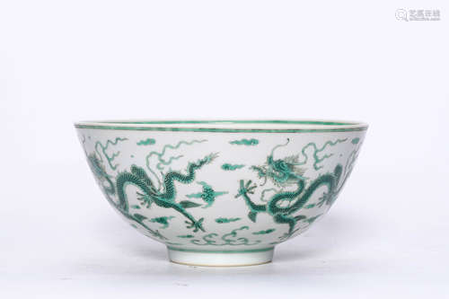 A GREEN COLOURED BOWL WITH DRAGON PATTERNS