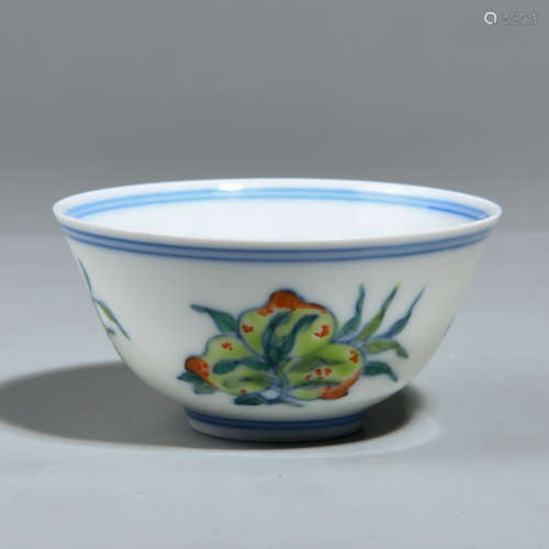 AN OVERGLAZED CUP WITH FLOWER AND FRUIT PATTERNS