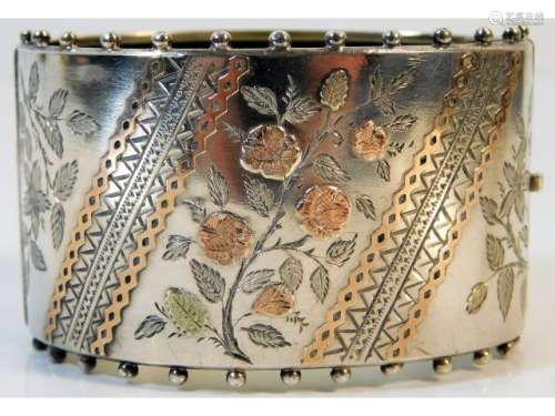 To followA 19thC. Birmingham silver bangle, date mark for 1883 with chased & applied yellow & rose c
