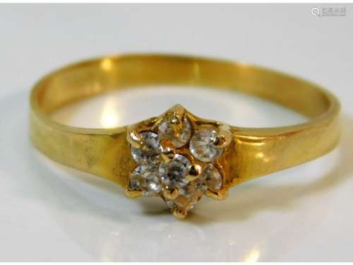 An 18ct gold ring set with seven diamonds of appro