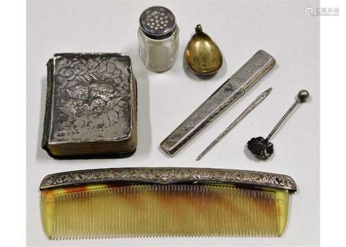 A silver covered miniature bible, a silver needle