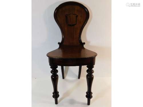 A 19thC. mahogany hall chair, 35.5in tall to back