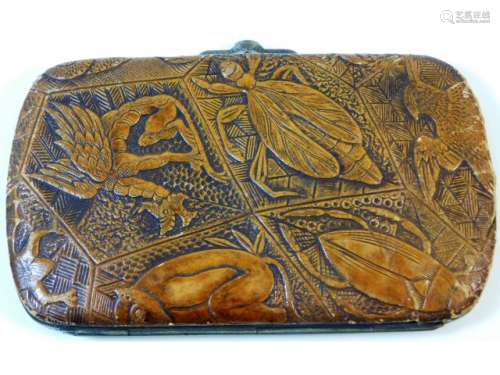An antique ladies purse decorated with carved deco