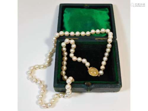 A cultured pearl necklace with Victorian 9ct rose gold clasp set with a possibly, cabochon cut yello