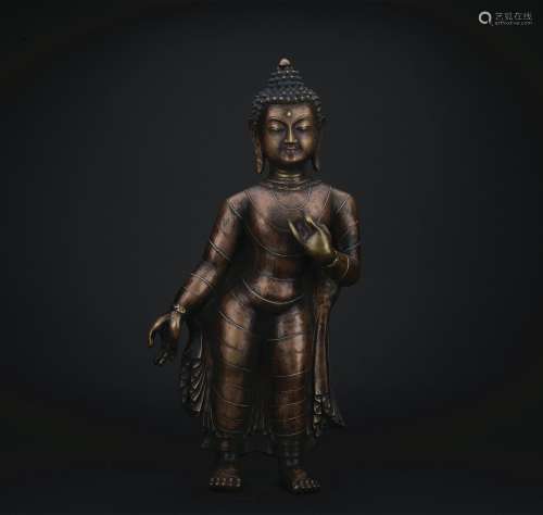 A gilt-bronze figure of standing buddha