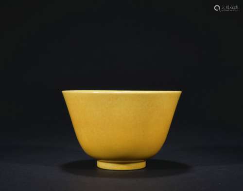 A yellow glazed cup