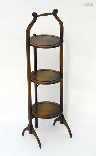 An early / mid 20thC folding three tier cake stand of oak construction. 36