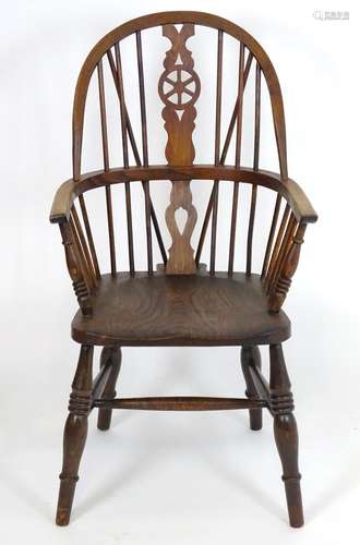 A 20thC Windsor armchair with an elm seat and double bow back with pierced back splat, the chair