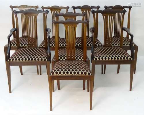 A set of eight early 20thC mahogany dining chairs by Druce & Co. The chairs having shaped cresting