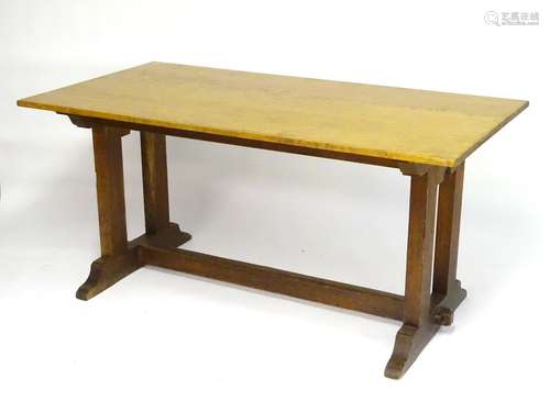 An early 20thC oak Cotswold school refectory table, with a proud top above two twin supports and a