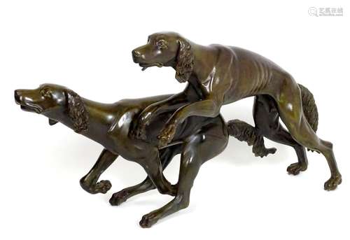 A 20thC large bronze sculpture modelled as two dogs / hounds running. Approx. 25