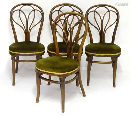 A set of four late 19thC Thonet bentwood chairs with shaped backrests and upholstered seats above