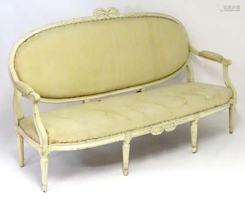 A late 19thC Louis XVI style sofa with a carved cresting rail above an upholstered back rest and