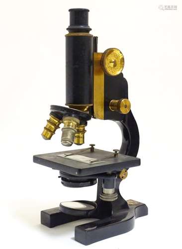 An early 20thC microscope, of cast metal construction, bearing maker's plaque for the Spencer Lens