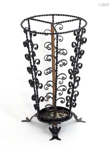 An early 20thC cast stick / umbrella stand with twist and scroll detail. Approx. 20